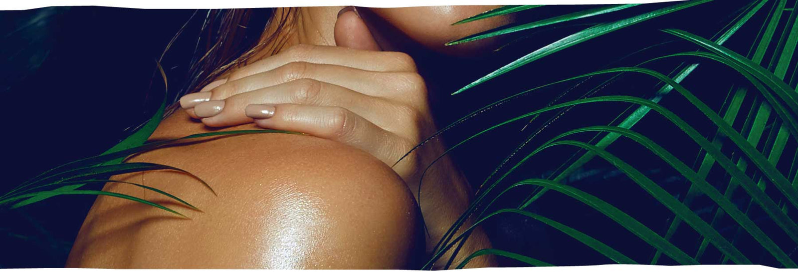 Person with hand on shoulder with leafy background.