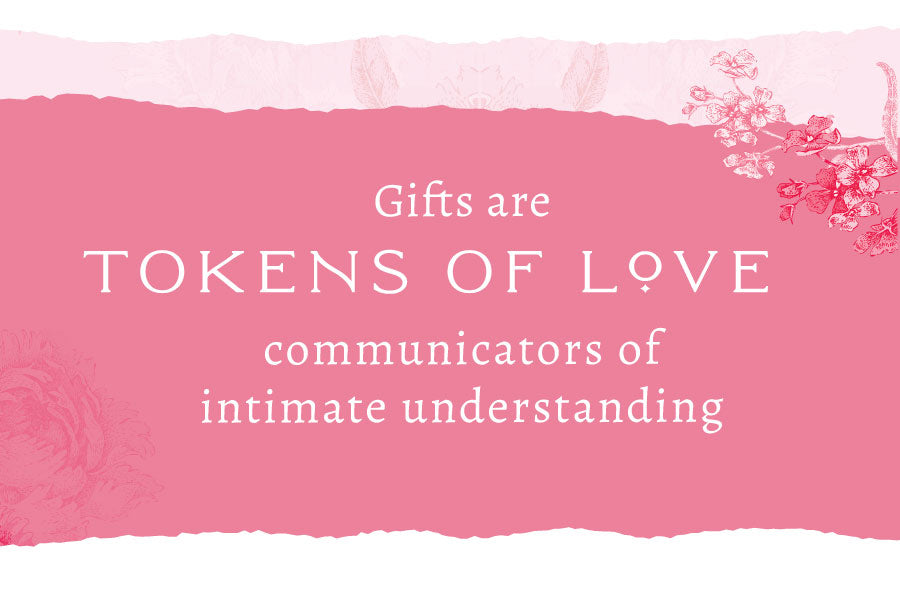 Pink banner with flowers on left and right sides with text that reads "Gifts are tokens of love, communicators of intimate understanding".